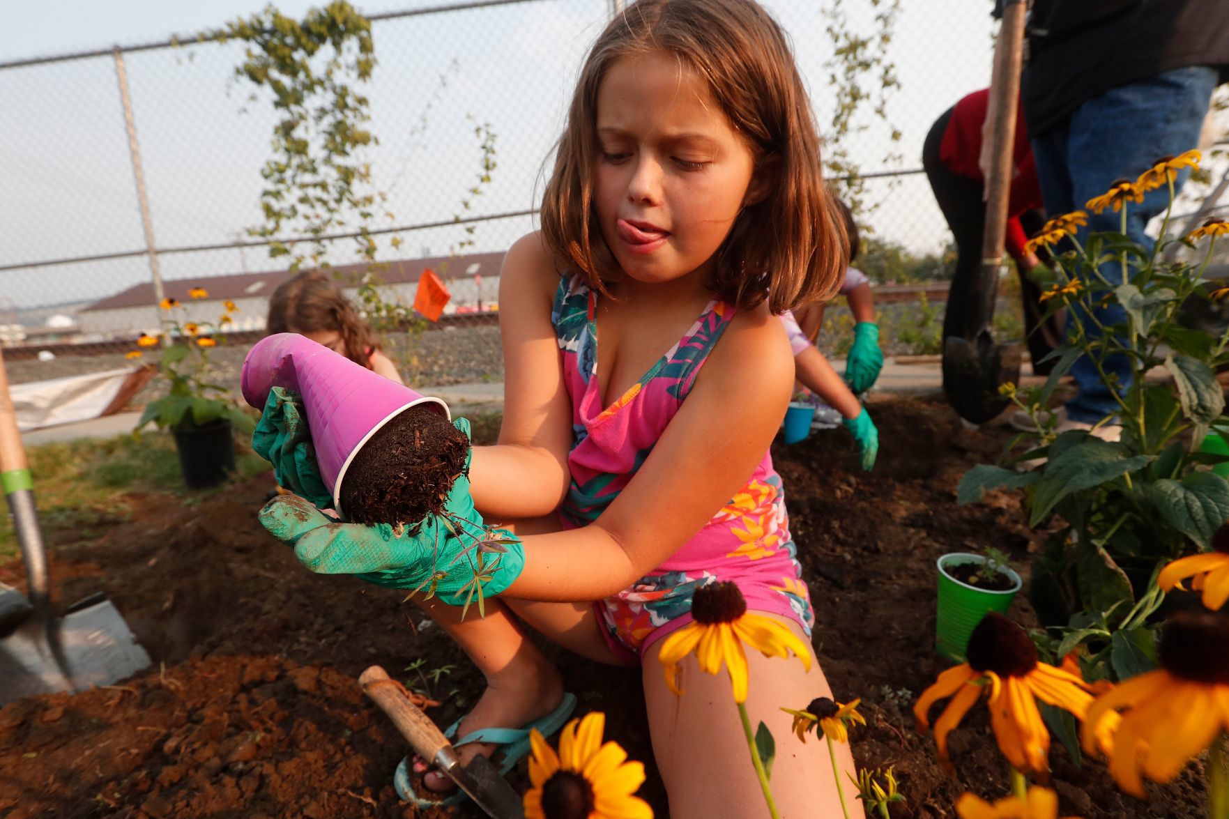 Girl Scouts plant flowers in Billings Depot Pocket Park